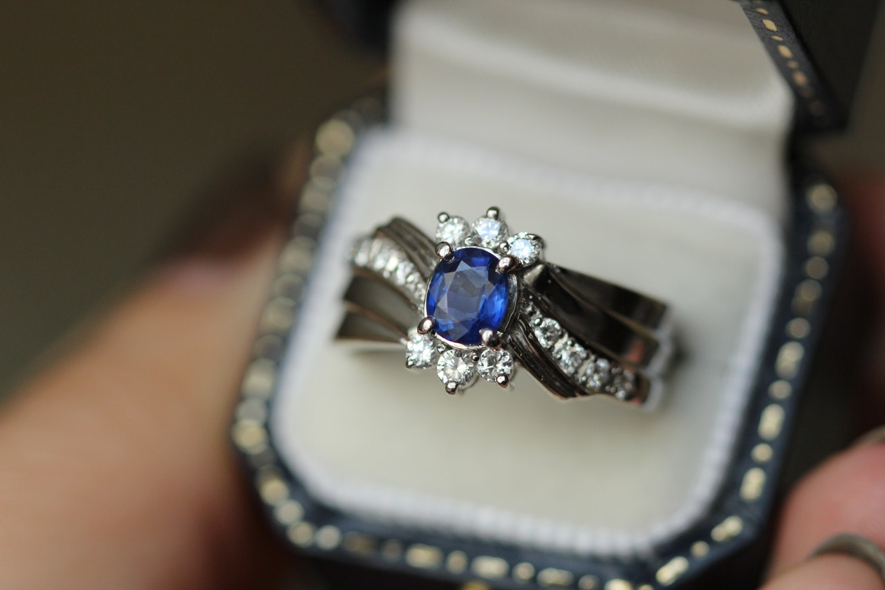 beautiful ring with diamonds and a big blue gem